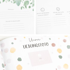 May include: A white baby memory book with a watercolor design of green leaves and yellow flowers. The book has a section for a favorite photo with the text "Unser Lieblingsfoto" and a space for a photo.