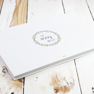 May include: White photo album with a green leafy wreath and the text "for immer and ever" in black.