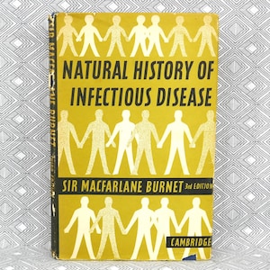 May include: A vintage book titled "Natural History of Infectious Disease" with a yellow cover and black text. The cover features white silhouettes of people holding hands. The author's name, Sir Macfarlane Burnet, is also visible.