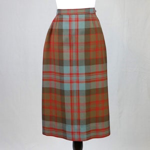May include: A long, brown, red and blue tartan skirt.
