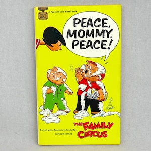 May include: A vintage paperback book titled "Peace, Mommy, Peace!" featuring a cartoon cover. The cover is bright yellow with cartoon illustrations of children covered in whipped cream. The Family Circus logo is visible.