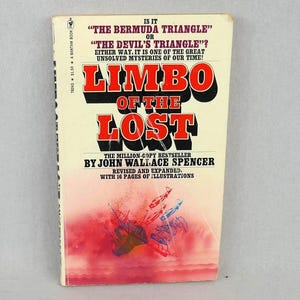 May include: A vintage paperback book titled "Limbo of the Lost" by John Wallace Spencer. The cover features bold red and black lettering against a cream background, with a graphic illustration of planes and ships.