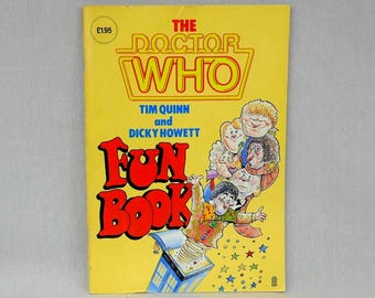 May include: A vintage "Doctor Who Fun Book" with a yellow cover. The title is in red and the book features cartoon illustrations of characters and a TARDIS. The cover also includes the text "Tim Quinn and Dicky Howett".