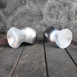 Tempered spring steel elbow cops