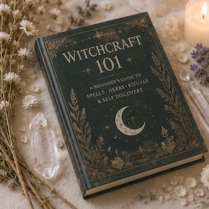 May include: A dark green hardback book titled Witchcraft 101: A Beginner's Guide to Spells, Herbs, Rituals & Self Discovery. The cover features gold foil botanical illustrations, a crescent moon, and stars, with a clear quartz crystal nearby.