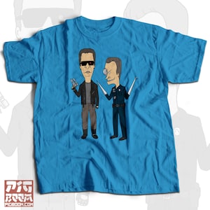May include: A blue t-shirt with a graphic of the Terminator and a character from the animated series King of the Hill. The Terminator is holding a gun and the King of the Hill character is holding a wrench.