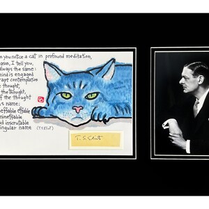 May include: A framed artwork featuring two images. One is a watercolor painting of a blue cat with green eyes and text. The other is a black and white portrait of a man in a suit.