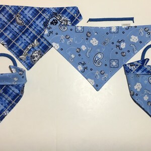 May include: Four blue and white patterned dog bandanas with a blue and white plaid pattern on the reverse side. Two of the bandanas have a blue elastic loop for easy attachment.