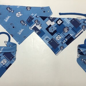 May include: Three blue and white patterned dog bandanas with the text "Tar Heels" and "North Carolina".
