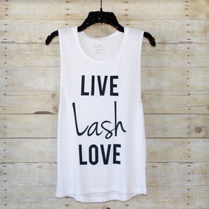 May include: White sleeveless tank top with the text "LIVE lash LOVE" printed in black.
