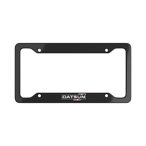 May include: Black license plate frame with the word "DATSUN" in white letters and a red, white, and blue stripe design.