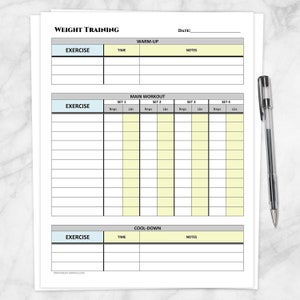 May include: A white weight training log sheet with sections for warm-up, main workout, and cool-down exercises. The main workout section includes spaces for reps and lbs across four sets. A black pen rests on the right side of the sheet.