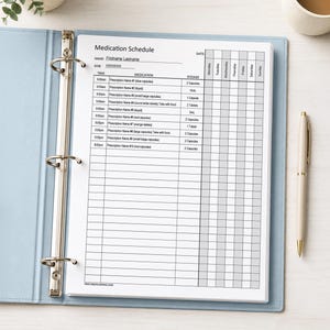 May include: A light blue three-ring binder containing a white Medication Schedule form. The document features columns for time, medication, dosage, and days of the week. The header reads Medication Schedule with fields for name, DOB, and date.