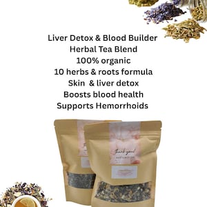 May include: Two brown paper pouches of herbal tea blend with a clear window, labeled "Liver Detox & Blood Builder." The text also reads "100% organic" and "10 herbs & roots formula." A cup of tea with a lemon slice is visible.