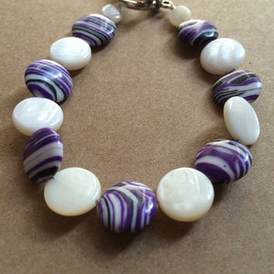 Purple & white, beaded bracelet, solids and stripes, flat disk shell beads.