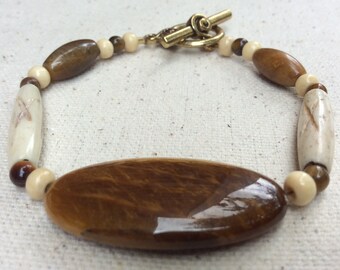 Oval tiger eye, beaded bracelet, tribal style, etched bone and wooden beads.