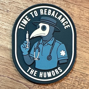 May include: Oval patch featuring a cartoon plague doctor in a blue uniform, stethoscope, and holding a syringe. The text "TIME TO REBALANCE THE HUMORS" is in white around the border. The patch has a black border and a white inner border.