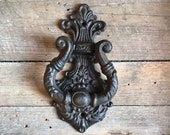 Vintage styled door knocker made of cast iron