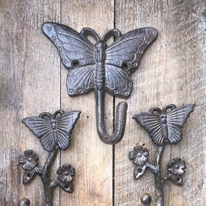 Large butterlfy wall hook made of cast iron. The perfect accent for your home. Fun and functional shown in the Aged Iron finish.