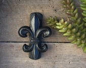 Fleur de lis door knocker for front door. Made of cast iron and finished in gunmetal black.