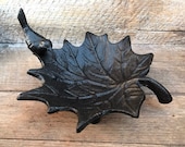 Maple leaf jewelry dish with a small bird. Solid and sturdy cast iron.
