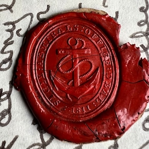 May include: A cracked, red wax seal with an anchor emblem and the text "SECRETARY'S OFFICE" and "1811" is pressed onto a piece of paper with handwritten script.