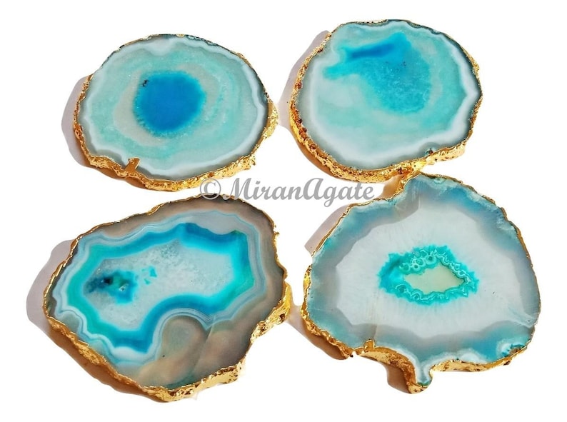 May include: Four agate coasters with gold trim. Each coaster features a unique blue and white agate pattern.