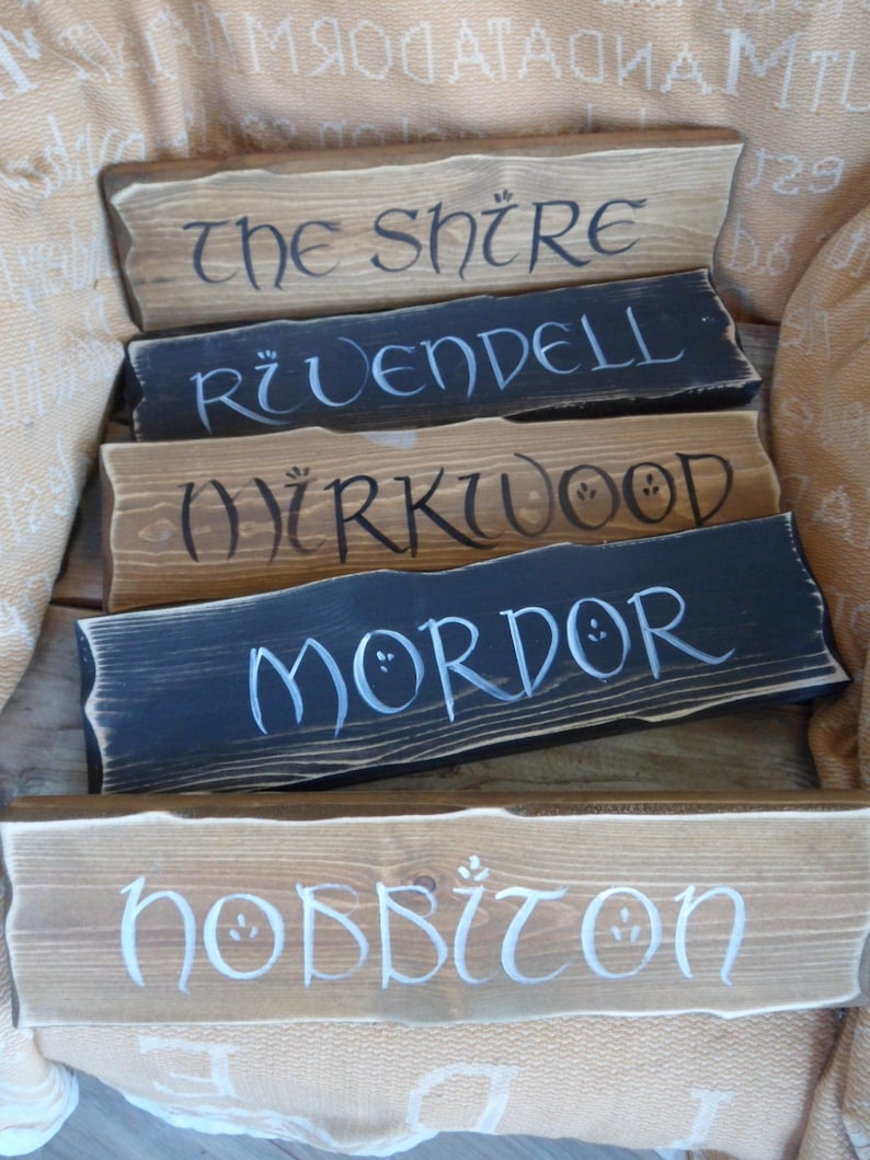 Pu&ograve; includere: Cinque cartelli in legno con lettere bianche, ognuno con un nome diverso dal Signore degli Anelli: La Contea, Gran Burrone, Bosco Atro, Mordor e la Contea degli Hobbit.