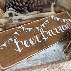 Beer Barrow sign decorated with bunting and ribbon