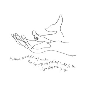 May include: A framed print featuring a minimalist line drawing of an open hand reaching upwards. The artwork is in black against a white background, with handwritten text at the bottom. The frame is a light wood color.
