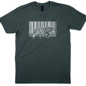 May include: Dark teal t-shirt with a white barcode design and a tiger silhouette. The barcode includes the numbers 0385926625. The shirt is a short-sleeved crew neck.