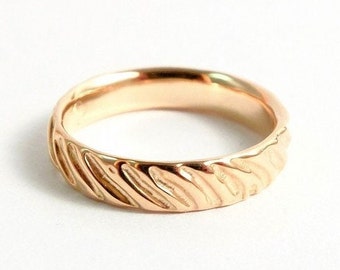 Delicate ring in 18k pink gold with wavy structure, surface with soft grooves, unique piece of jewelry, gift women