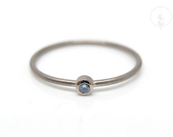 Thin white gold ring with blue diamond, light blue diamond ring made of 14K white gold, delicate engagement ring with ice blue brilliant in desired size