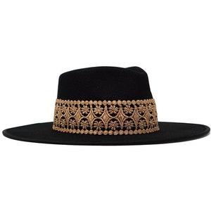 May include: A black felt fedora hat with a wide brim and a gold embroidered band.