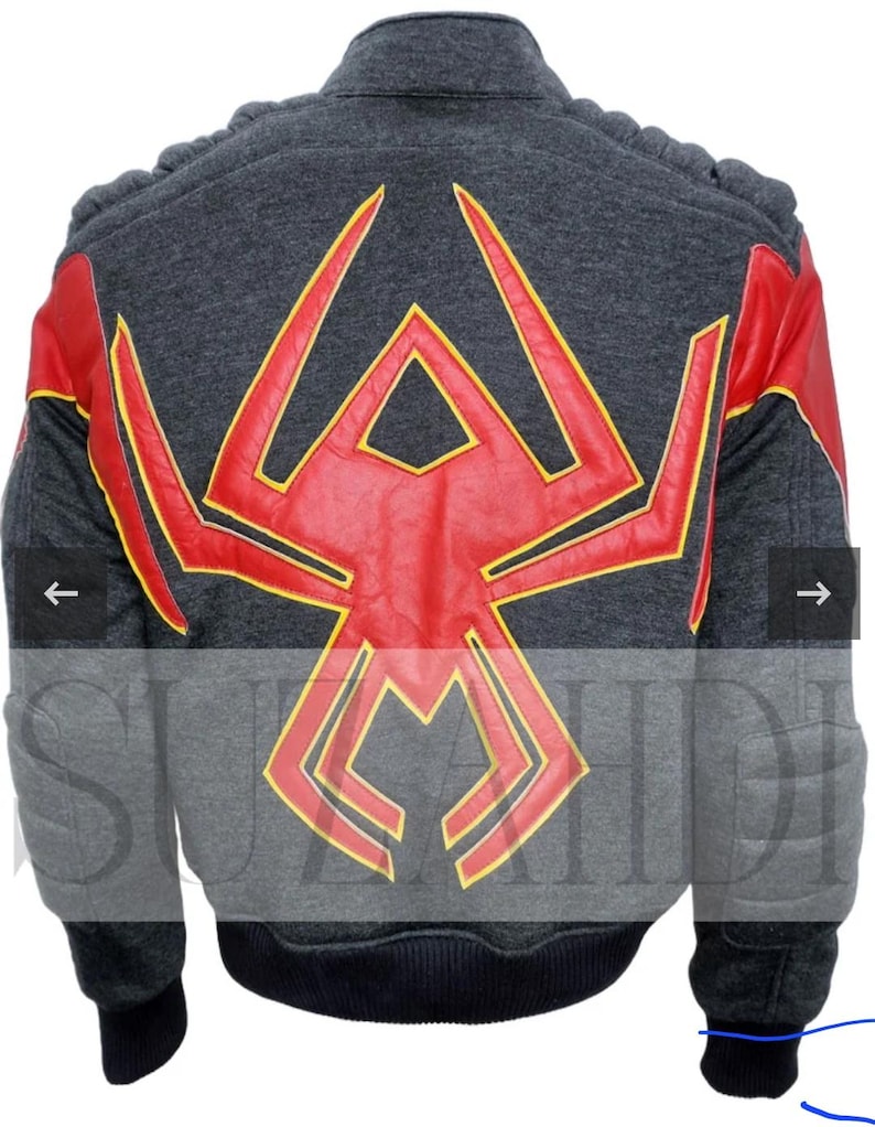 May include: A charcoal gray jacket featuring a large red spider emblem with yellow trim on the back. The jacket has red sleeves with yellow accents, ribbed black cuffs, and a ribbed black hem. The shoulders and elbows have padded detailing.
