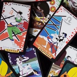 May include: A set of tarot cards with colourful illustrations and black borders. The cards feature the names "Five of Wands", "Seven of Wands", and "Pratikar".