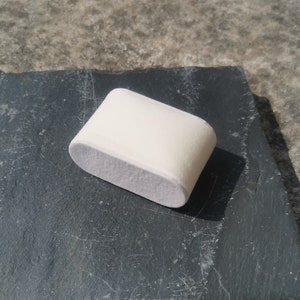 May include: A white oval-shaped polishing pad for buffing and polishing surfaces.