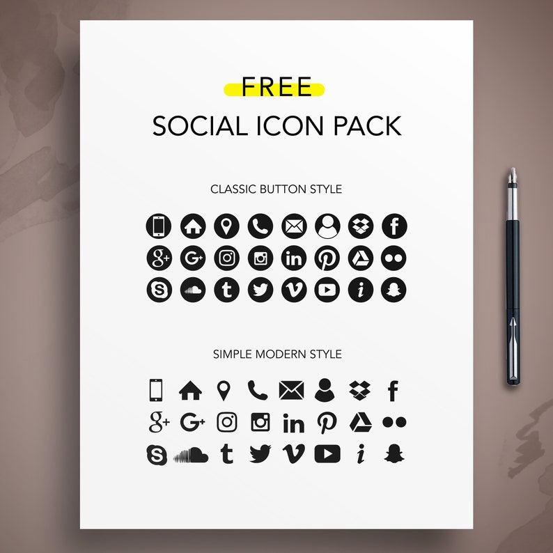 May include: A white sheet with the text "FREE SOCIAL ICON PACK" and two rows of black social media icons in classic button and simple modern styles. A black pen rests on the right side of the sheet.