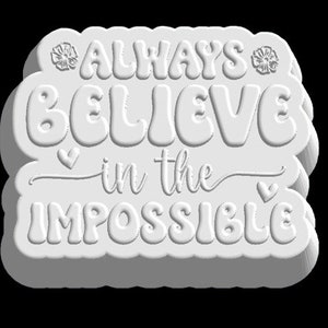 May include: White 3D sign with the text "ALWAYS BELIEVE in the IMPOSSIBLE" in a stylized font. The sign has two small flower designs and two small heart designs.