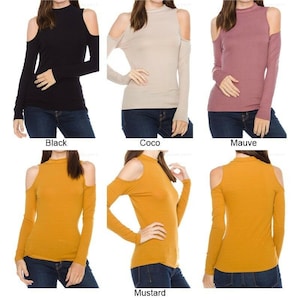 May include: Four different color mock neck shirts with cold shoulder cutouts. The shirts are shown on models wearing blue jeans. The colors are black, beige, mauve, and mustard.