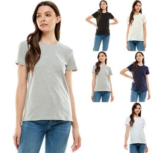 May include: Five women are wearing different colored t-shirts. The t-shirts are all short-sleeved and crew neck. The women are wearing jeans.