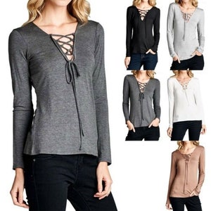 May include: Five long-sleeved shirts with a lace-up V-neck. The shirts are in black, gray, white, and brown.