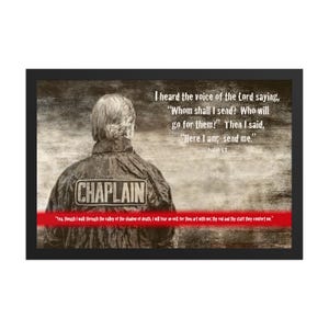 May include: A framed sepia-toned print featuring a person seen from behind wearing a jacket with the word CHAPLAIN on the back. The text reads: I heard the voice of the Lord saying, Whom shall I send? Then I said, Here I am; send me. Isaiah 6:8.
