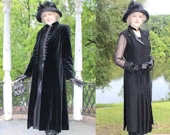May include: Two women wearing black velvet coats and hats with black gloves and boots. One woman is holding a black clutch purse.