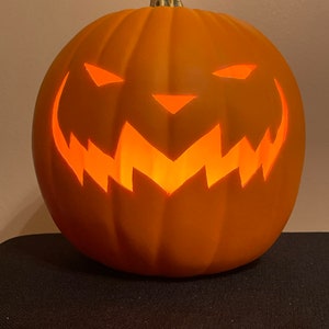 Pumpkin king face carved out of orange 9” foam Pumpkin
