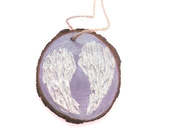 WOOD WINGS ORNAMENT - 2.5" Christmas Ornament on a Wood Tree Slice with White and Silver Wings on a Gray Background