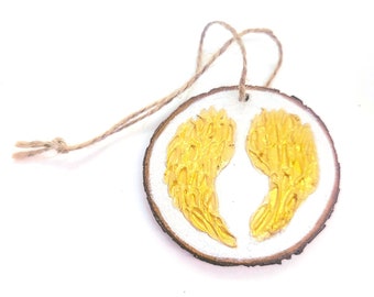 WOOD WINGS ORNAMENT - 2.5" Christmas Ornament on a Wood Tree Slice with Gold Wings on a White Background