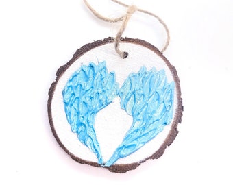 WOOD WINGS ORNAMENT - 2.5" Christmas Ornament on a Wood Tree Slice with Turquoise Blue and Silver Wings on a White Background