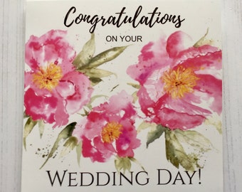 May include: A white card with pink watercolor flowers and the text "Congratulations on your Wedding Day!"
