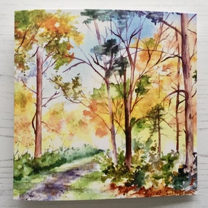 May include: Watercolor painting of a forest path with trees in autumn colors. The trees are a mix of yellow, orange, red, and green. The path is winding through the trees and leads to a clearing in the distance.